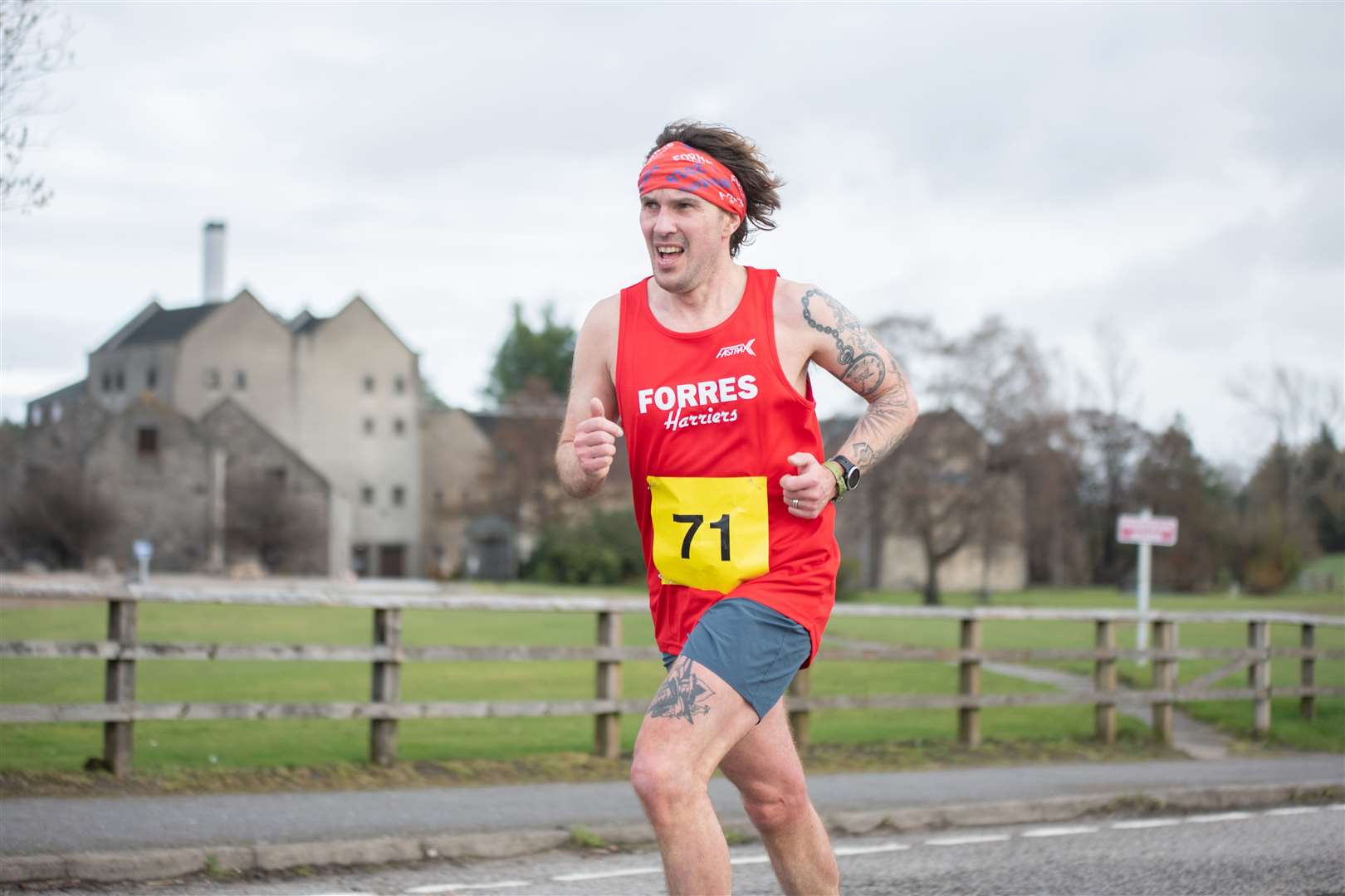 Passing Miltonduff Distillery as he approaches the finishline - Forres Harriers' James Ward.Moray Road Runners 2024 10k Race.Picture: Daniel Forsyth.